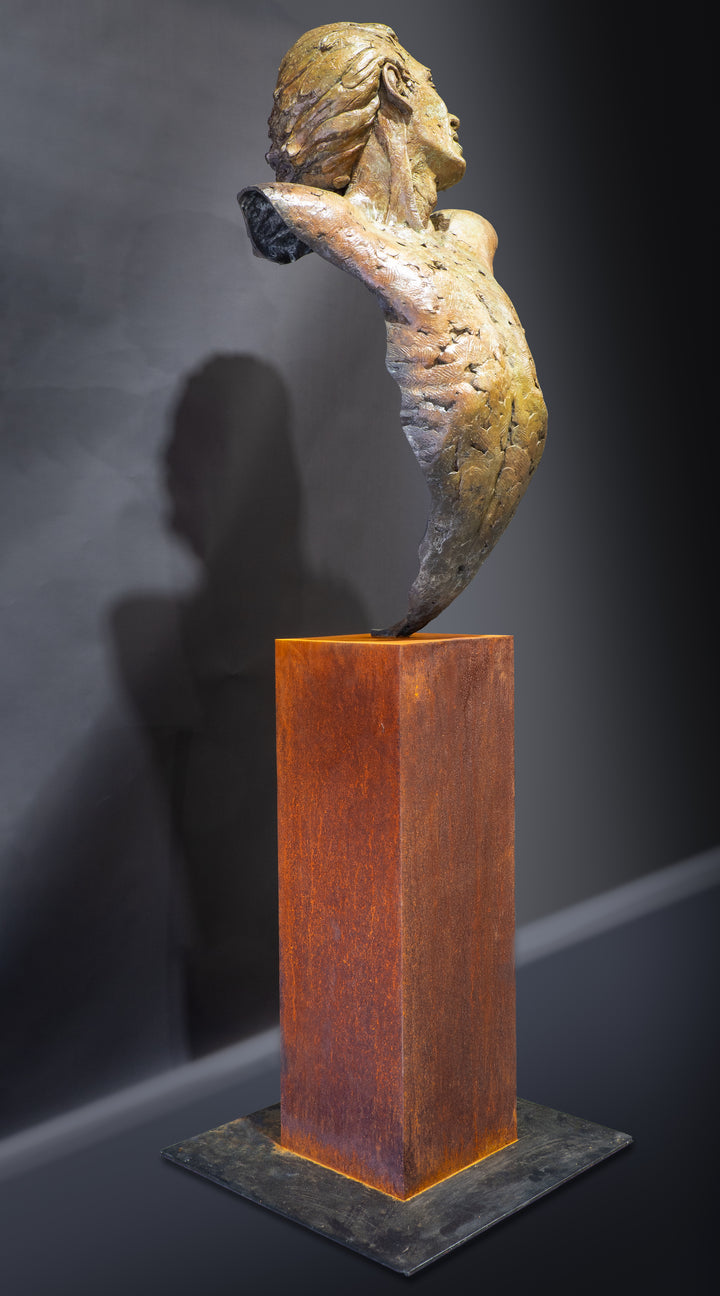 Nicola Godden Bliss Icarus bronze sculpture portraying a stylised human figure rising upward with arms extended and head turned, evoking a moment of release and quiet strength. The elongated form suggests lift and motion while remaining grounded through a solid Corten steel base. The textured bronze surface carries depth and variation, with light catching across its contours to enhance the sense of movement and presence.