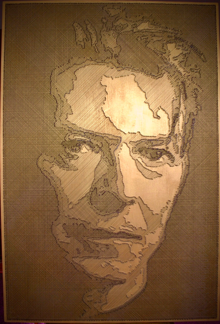 Portrait of David Bowie formed from fine black enamelled copper wire tensioned around thousands of small nails on a gold-toned board, with layered linear wiring defining facial features and hair through tonal contrast, depth and shadow across a textured metallic surface that shifts with light and viewing angle.