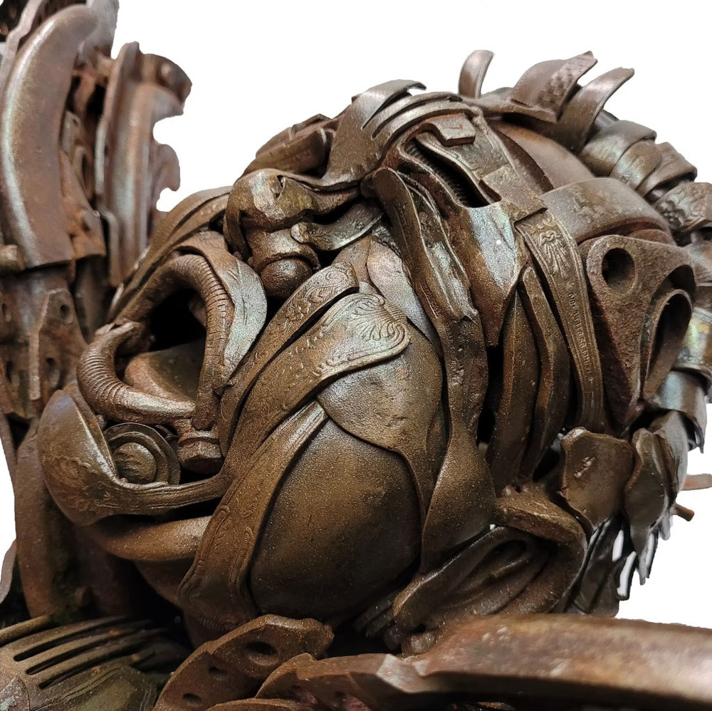 Fantasy warrior sculpture made from reclaimed metal with mechanical wings, gears, and armour detailing.
