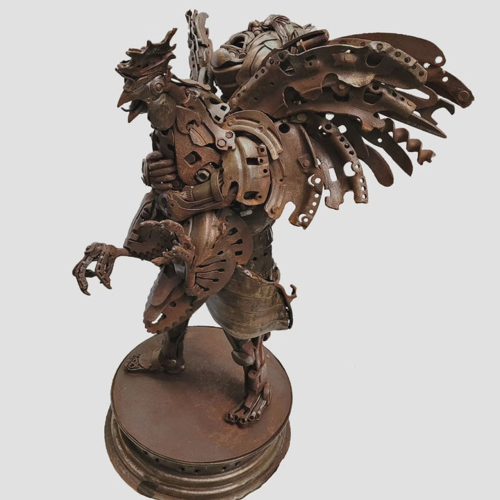 Fantasy warrior sculpture made from reclaimed metal with mechanical wings, gears, and armour detailing.