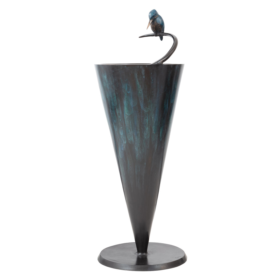 ‘Halcyon Days’ by Pat Bull, a limited-edition contemporary bronze wildlife sculpture and functional birdbath featuring a kingfisher perched on a curved bronze support above a circular basin designed to hold water. The bird features vivid turquoise and deep blue patina, a warm bronze breast and a polished golden beak, with its head lowered towards the reflective water below. The tall, tapered conical birdbath has a textured verdigris finish in charcoal, teal and blue-green tones, supported by a circular dark