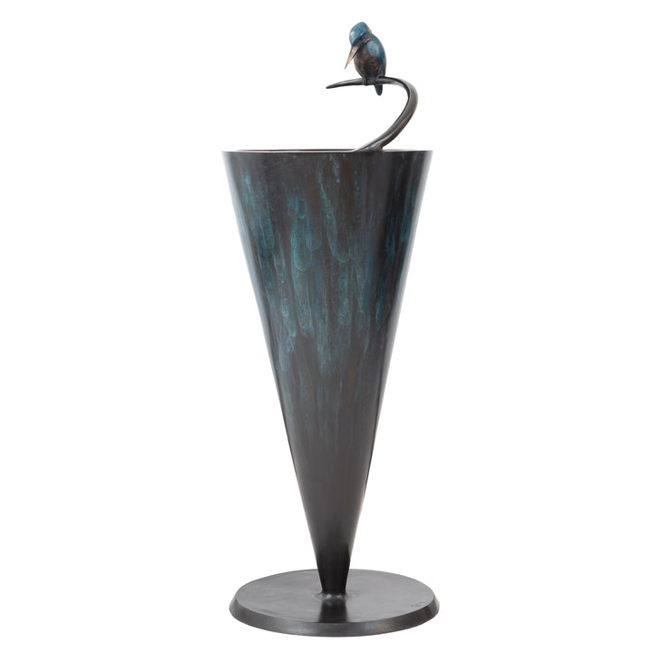 ‘Halcyon Days’ by Pat Bull, a limited-edition contemporary bronze wildlife sculpture and functional birdbath featuring a kingfisher perched on a curved bronze support above a circular basin designed to hold water. The bird features vivid turquoise and deep blue patina, a warm bronze breast and a polished golden beak, with its head lowered towards the reflective water below. The tall, tapered conical birdbath has a textured verdigris finish in charcoal, teal and blue-green tones, supported by a circular dark