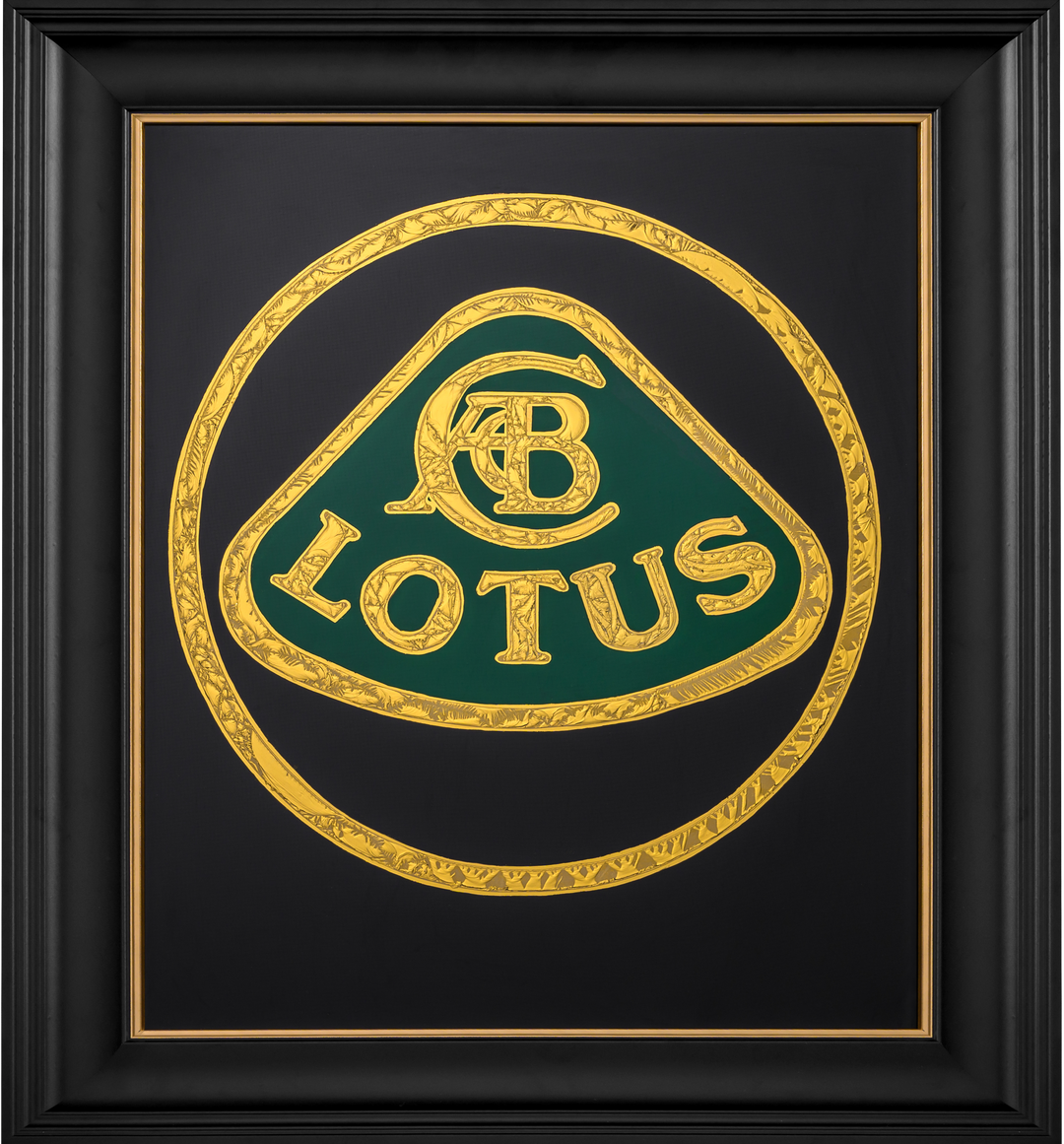 ‘CC Passion’ by Vince Edmunds, a handcrafted automotive artwork celebrating the British Lotus marque, featuring the classic Lotus emblem recreated in 24-carat gold leaf and glue-chipped glass. Intricately textured gold lettering and circular detailing surround the distinctive green Lotus badge against a deep black background, presented in a satin black frame with a fine gold sight line.
