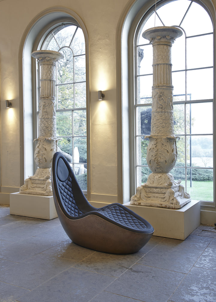 “Caillou Chaise – Leather & Bronze” by Ben Rousseau – a sculptural chaise combining deep navy quilted leather with a liquid bronze base. A handcrafted fusion of strength and sophistication, redefining modern luxury furniture.

