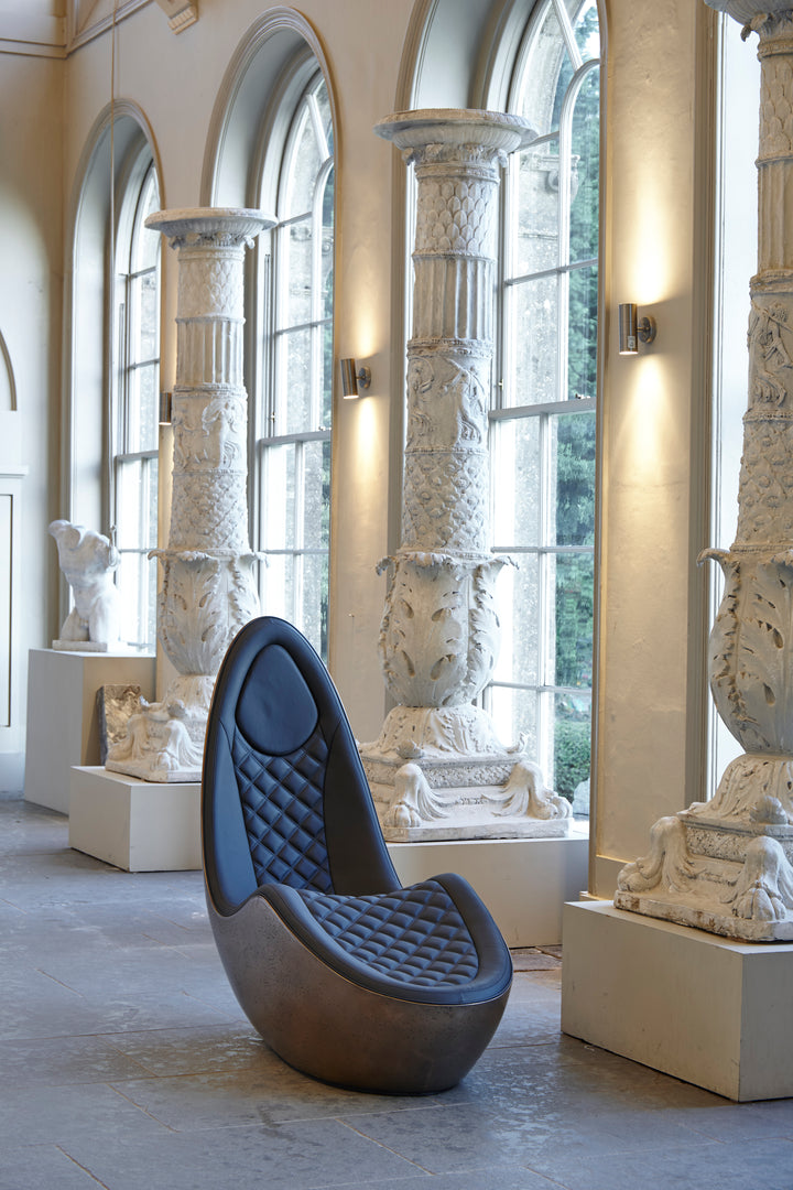 “Caillou Chaise – Leather & Bronze” by Ben Rousseau – a sculptural chaise combining deep navy quilted leather with a liquid bronze base. A handcrafted fusion of strength and sophistication, redefining modern luxury furniture.

