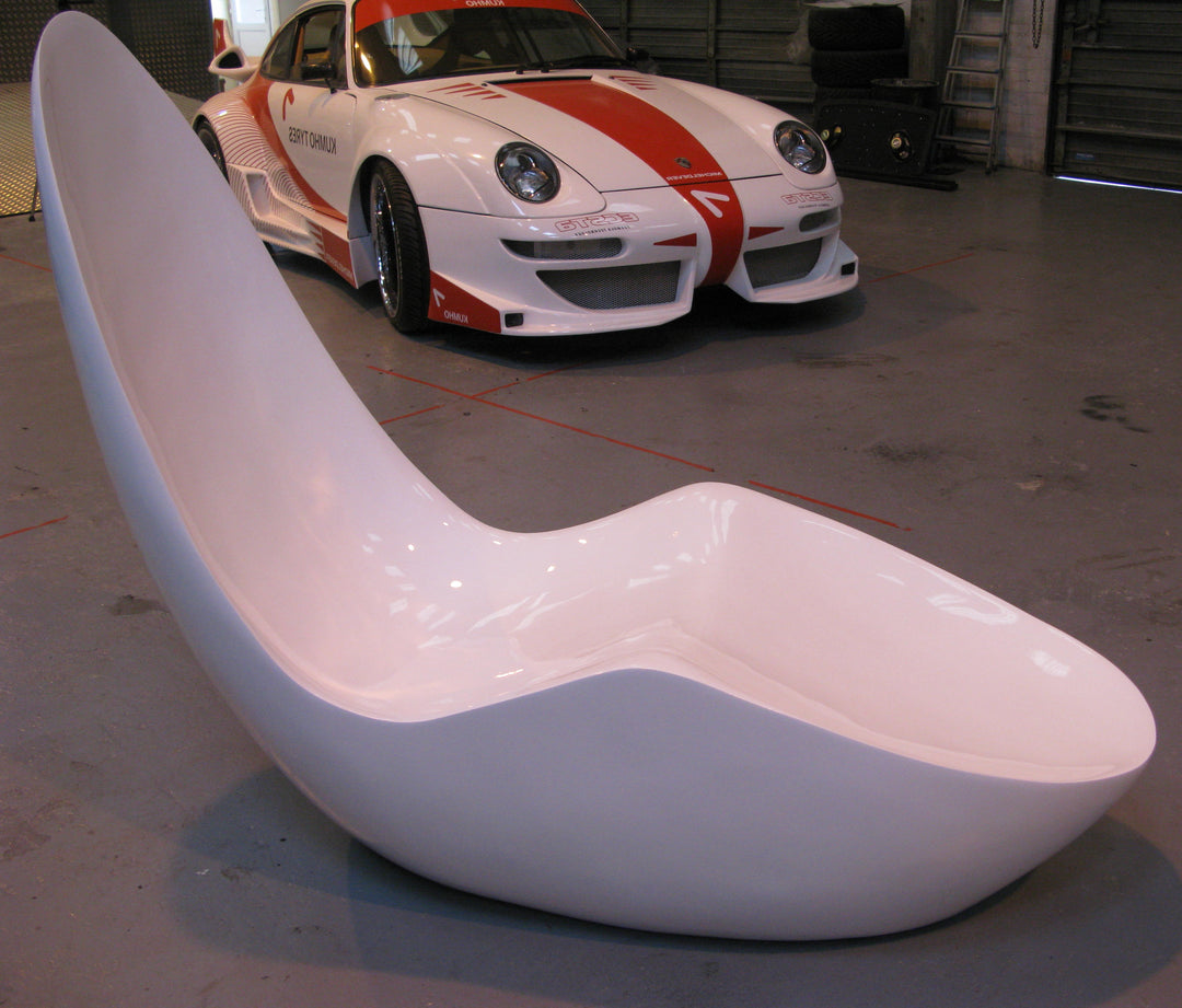 “Caillou Chaise – Metallic Wet Spray” by Ben Rousseau – a sculptural chaise inspired by 1960s grand tourers, hand-shaped in composite with a high-gloss metallic lacquered finish in white, lime, gold, or silver. A fusion of luxury design and form.