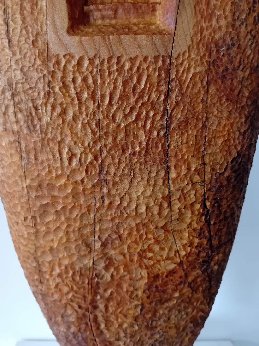 Nicola Beattie CAMINO sculpture — hand-carved cedar monolith with textured chisel-marked surface and arched window opening, symbolising a pilgrimage through life and a path towards hope. One-off original wooden artwork on cedar base.