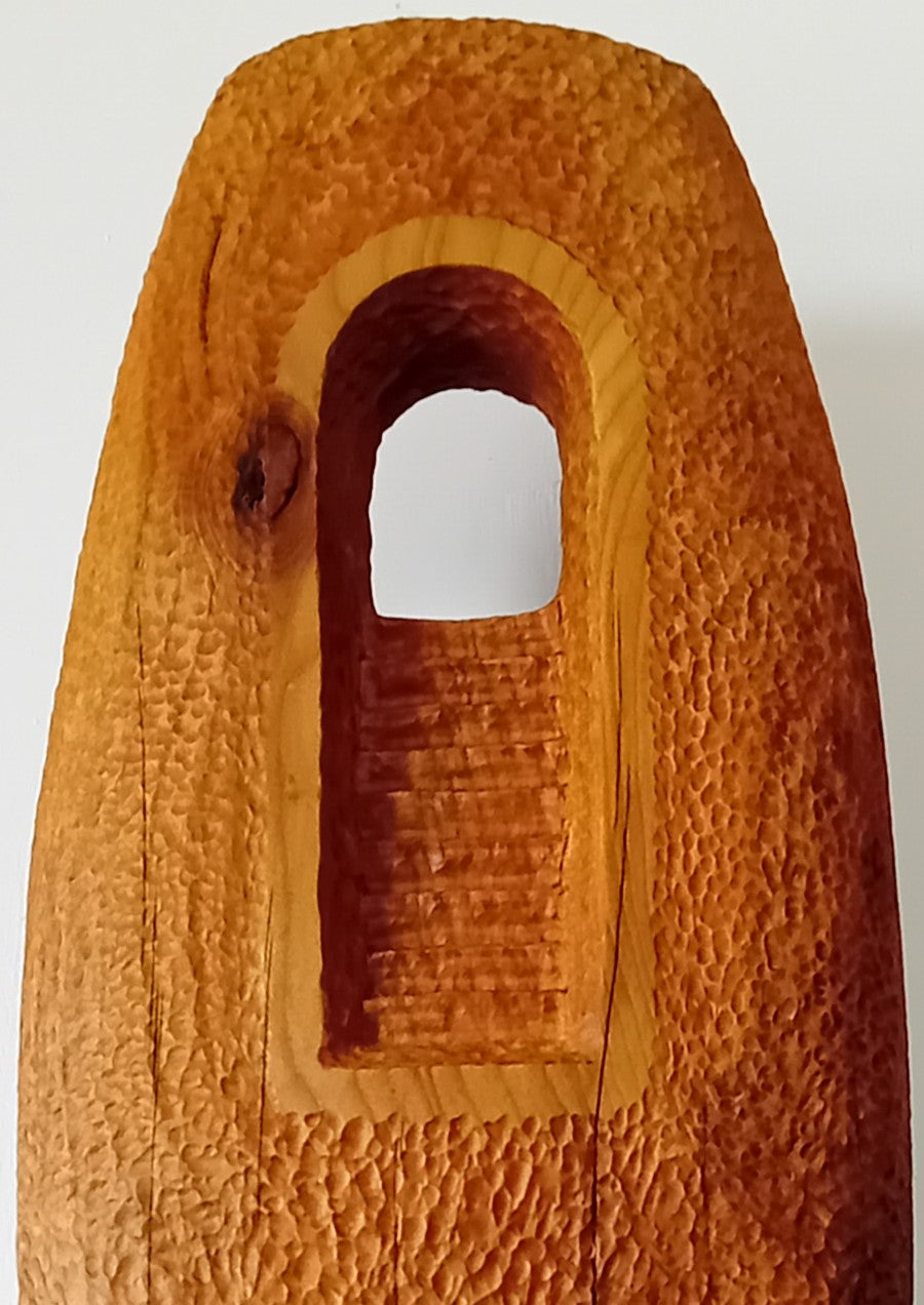 Nicola Beattie CAMINO sculpture — hand-carved cedar monolith with textured chisel-marked surface and arched window opening, symbolising a pilgrimage through life and a path towards hope. One-off original wooden artwork on cedar base.