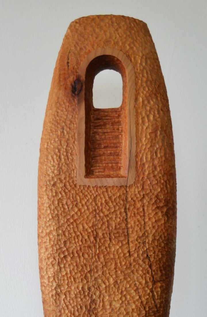 “Camino” by Nicola Beattie – a hand-carved cedar sculpture on an oak base symbolising endurance, renewal, and hope. Part of the Monolith series, it embodies the idea of life’s pilgrimage and the journey toward light and peace.