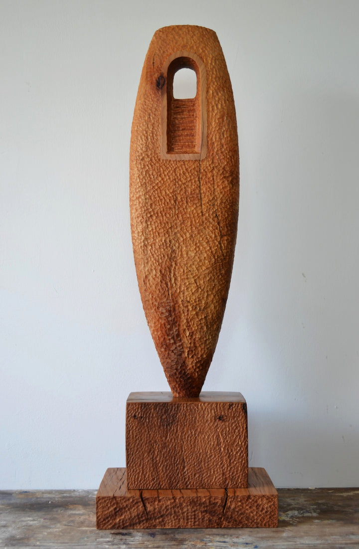 “Camino” by Nicola Beattie – a hand-carved cedar sculpture on an oak base symbolising endurance, renewal, and hope. Part of the Monolith series, it embodies the idea of life’s pilgrimage and the journey toward light and peace.