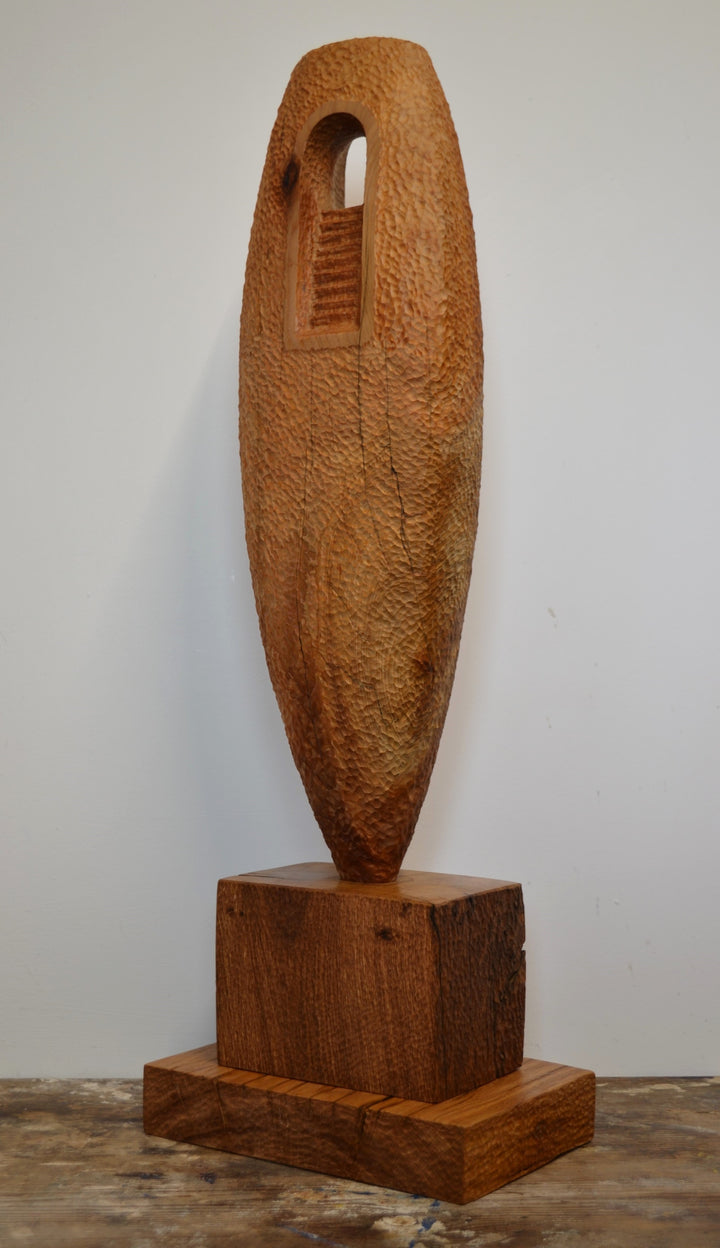 “Camino” by Nicola Beattie – a hand-carved cedar sculpture on an oak base symbolising endurance, renewal, and hope. Part of the Monolith series, it embodies the idea of life’s pilgrimage and the journey toward light and peace.