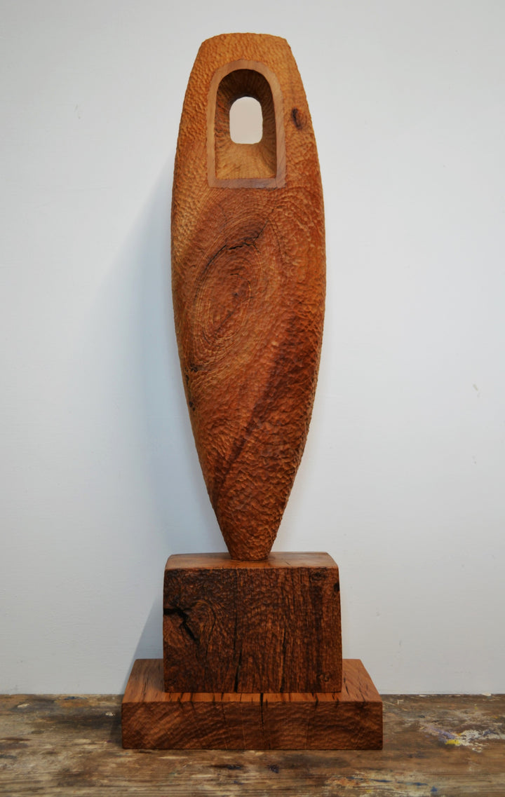 “Camino” by Nicola Beattie – a hand-carved cedar sculpture on an oak base symbolising endurance, renewal, and hope. Part of the Monolith series, it embodies the idea of life’s pilgrimage and the journey toward light and peace.