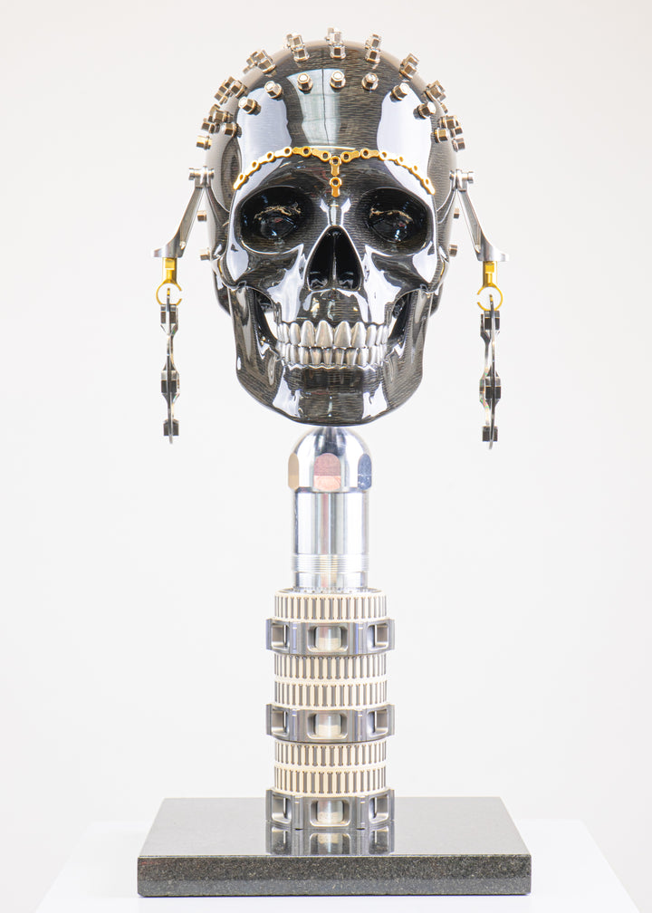 Alastair Gibson CarbonArt45 carbon fibre skull sculpture with high-gloss finish, Formula One components, stainless steel bolt crown detail, gold-plated accents and precision-engineered metal base
