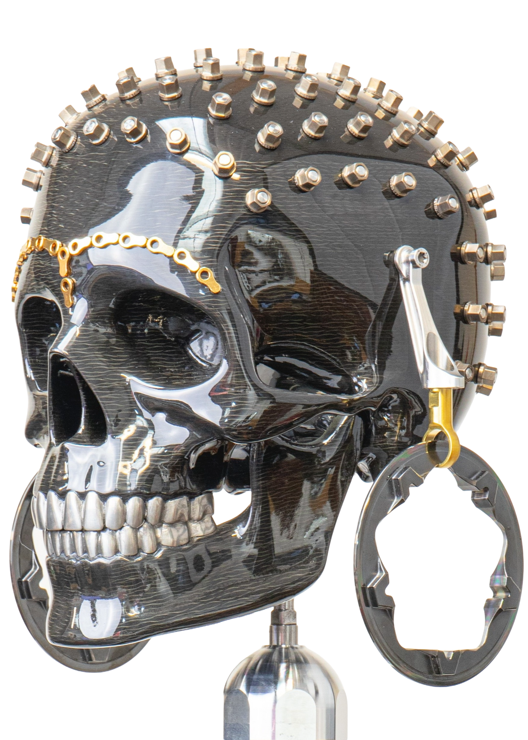 Alastair Gibson CarbonArt45 carbon fibre skull sculpture with high-gloss finish, Formula One components, stainless steel bolt crown detail, gold-plated accents and precision-engineered metal base