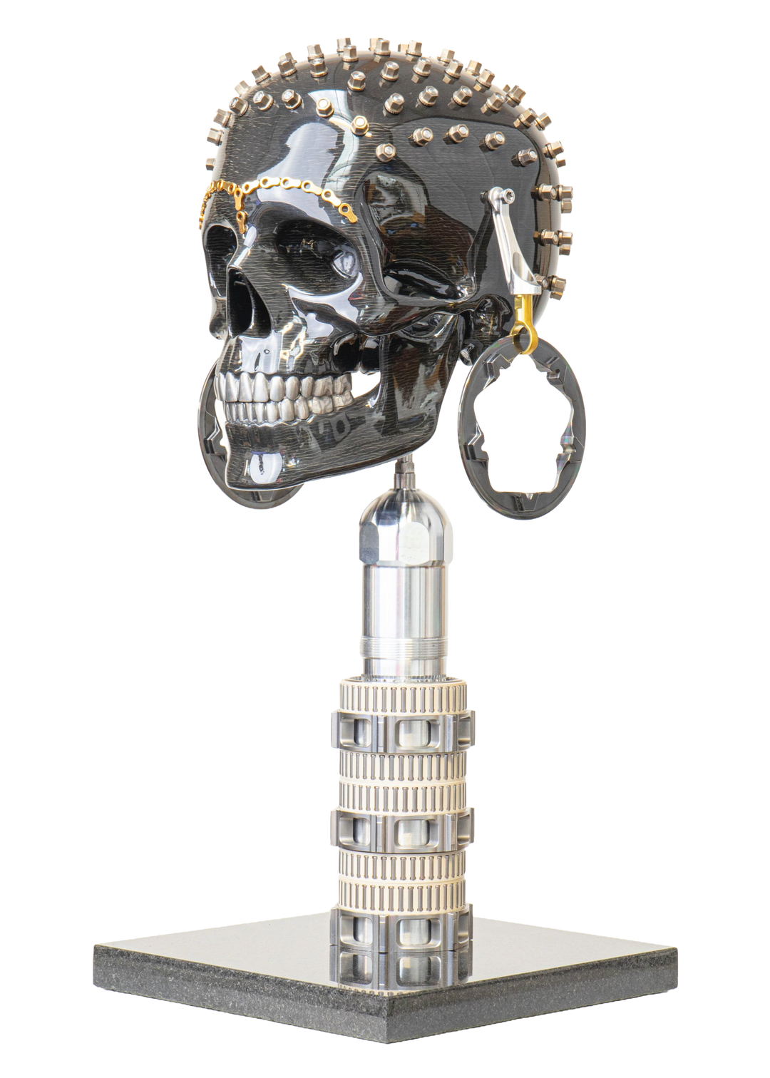 Alastair Gibson CarbonArt45 carbon fibre skull sculpture with high-gloss finish, Formula One components, stainless steel bolt crown detail, gold-plated accents and precision-engineered metal base