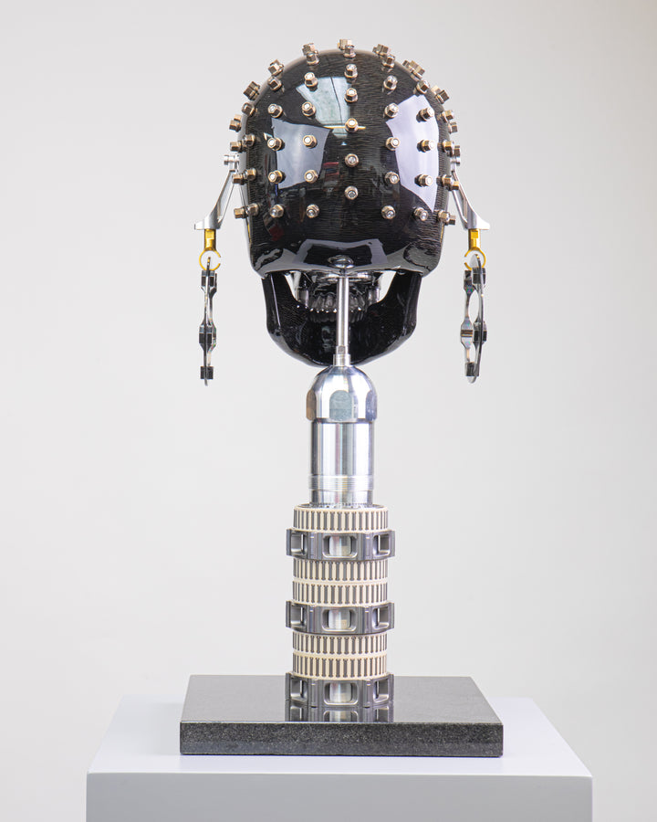 Alastair Gibson CarbonArt45 carbon fibre skull sculpture with high-gloss finish, Formula One components, stainless steel bolt crown detail, gold-plated accents and precision-engineered metal base