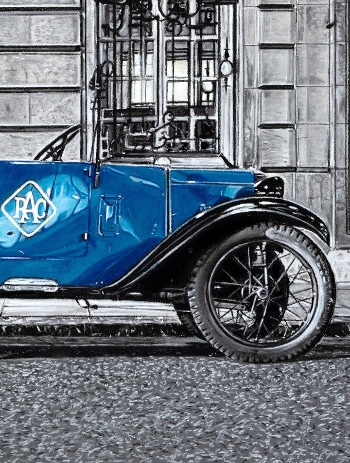 Pastel artwork depicting a 1930 Austin Seven Tourer parked on Pall Mall outside the Royal Automobile Club, with the vivid blue car set against a grand stone façade, illuminated by soft lamplight and surrounded by muted grey architecture, textured paving and evening shadows rendered with fine tonal control and surface detail.