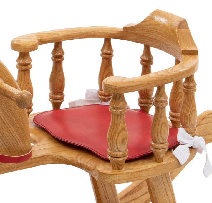 Oak baby rocker with red leather seat, safety rails, and red bridle, designed for toddlers.

