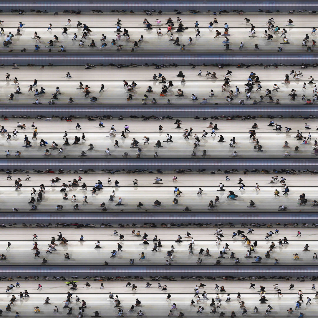 High-angle composite image of Hong Kong commuters moving through a brightly lit station, captured using high-speed video reconstruction. The figures are partially blurred and distorted, their faces downturned toward phones—creating a visual rhythm that blurs individuality, echoing the dehumanising pace of mass transit systems.