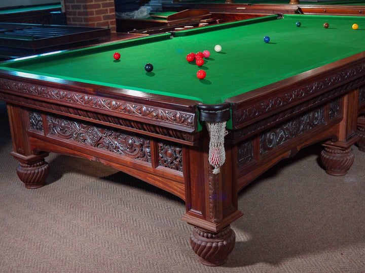 Orme & Sons Arts & Crafts billiard table c.1890 in flamed mahogany with intricate carved detailing and traditional green cloth.