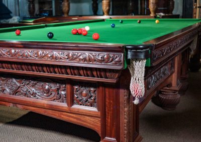 Orme & Sons Arts & Crafts billiard table c.1890 in flamed mahogany with intricate carved detailing and traditional green cloth.
