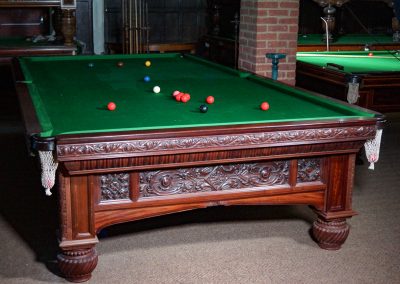 Orme & Sons Arts & Crafts billiard table c.1890 in flamed mahogany with intricate carved detailing and traditional green cloth.