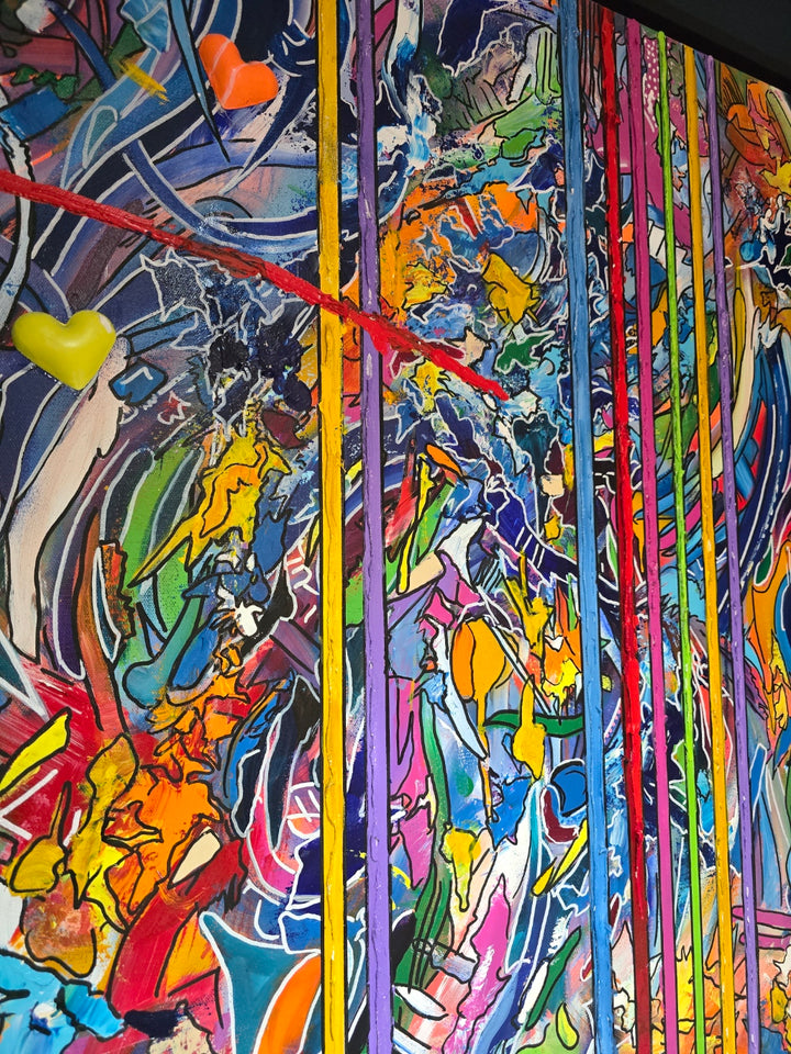 A vibrant abstract graffiti painting filled with layered colours, bold linework and dripping textures, with vertical multicoloured stripes cutting through the centre and two small 3D resin hearts emerging from the surface. The artwork blends chaotic movement with structured lines, creating a vivid, energetic, contemporary statement piece.