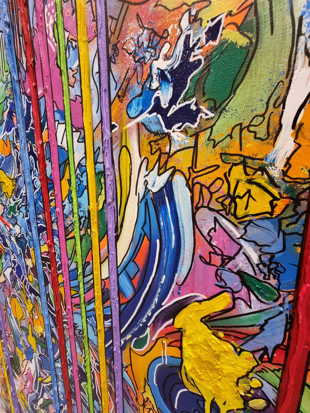 A vibrant abstract graffiti painting filled with layered colours, bold linework and dripping textures, with vertical multicoloured stripes cutting through the centre and two small 3D resin hearts emerging from the surface. The artwork blends chaotic movement with structured lines, creating a vivid, energetic, contemporary statement piece.