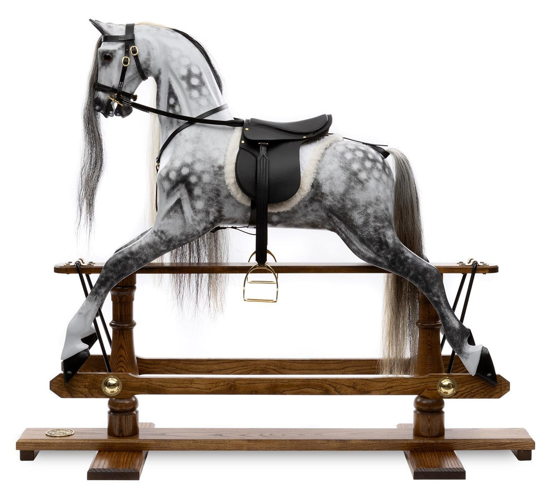 Hand-painted dapple grey rocking horse with long black and white mane, black leather saddle, and oak safety stand.

