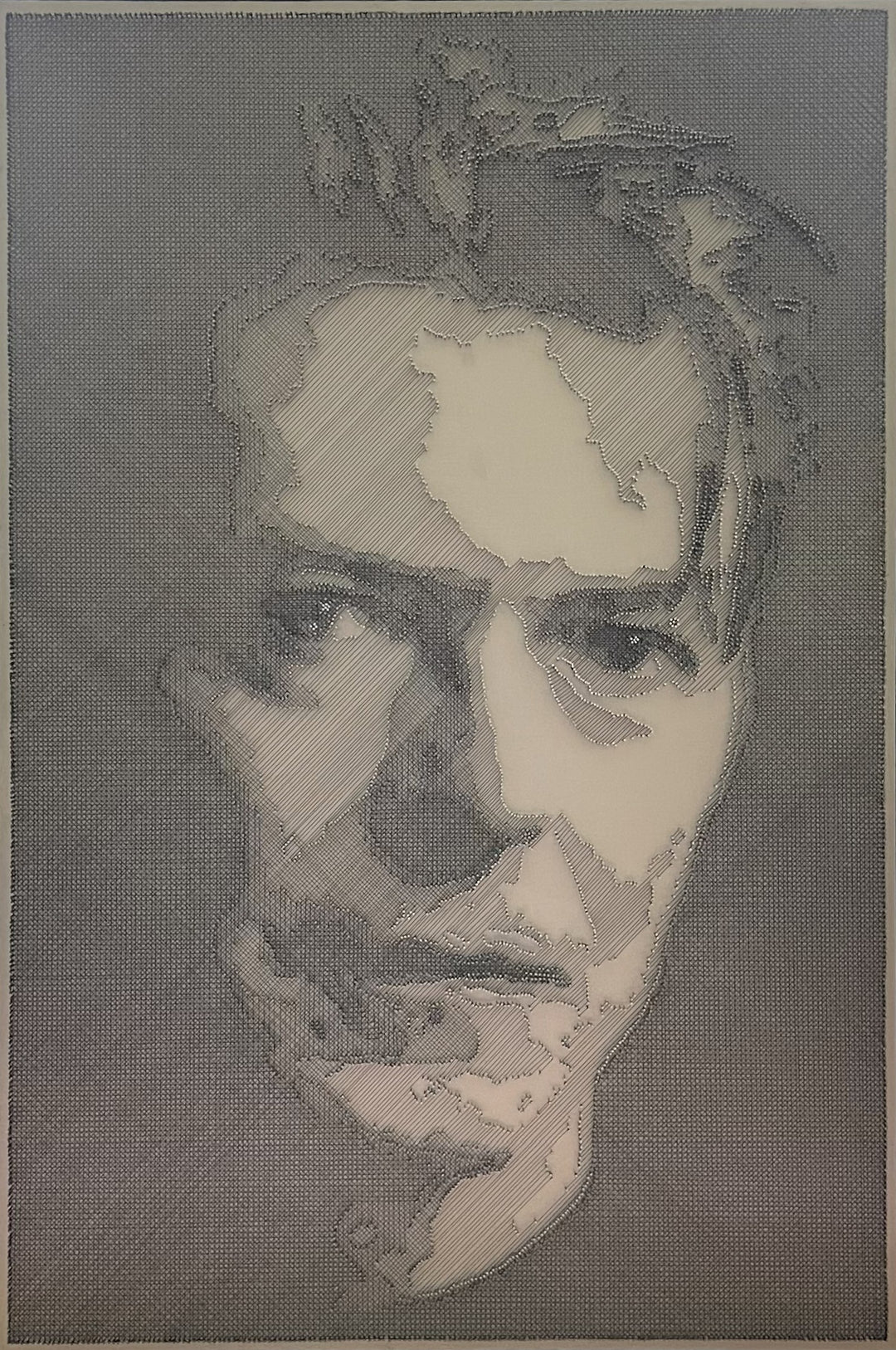Portrait of David Bowie constructed from fine black enamelled copper wire tensioned around thousands of small metal nails on a silver acrylic painted board, forming dense linear layers that define facial features, hair and expression through tonal variation, depth and shadow across a rigid rectangular surface.