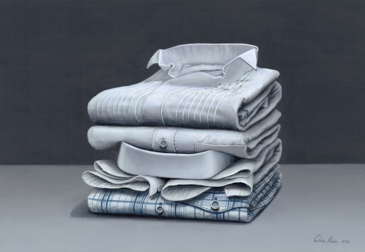 Hyperrealist painting of five neatly folded dress shirts stacked on a smooth grey surface against a dark grey backdrop. The artwork features a meticulous study in light, texture, and subtle detail, with varying collar styles, stitching, and one checked blue shirt anchoring the base.