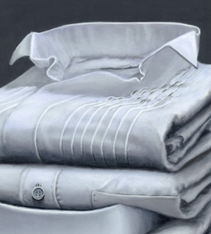 Hyperrealist painting of five neatly folded dress shirts stacked on a smooth grey surface against a dark grey backdrop. The artwork features a meticulous study in light, texture, and subtle detail, with varying collar styles, stitching, and one checked blue shirt anchoring the base.