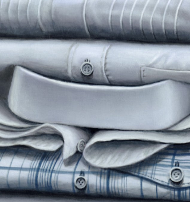 Hyperrealist painting of five neatly folded dress shirts stacked on a smooth grey surface against a dark grey backdrop. The artwork features a meticulous study in light, texture, and subtle detail, with varying collar styles, stitching, and one checked blue shirt anchoring the base.