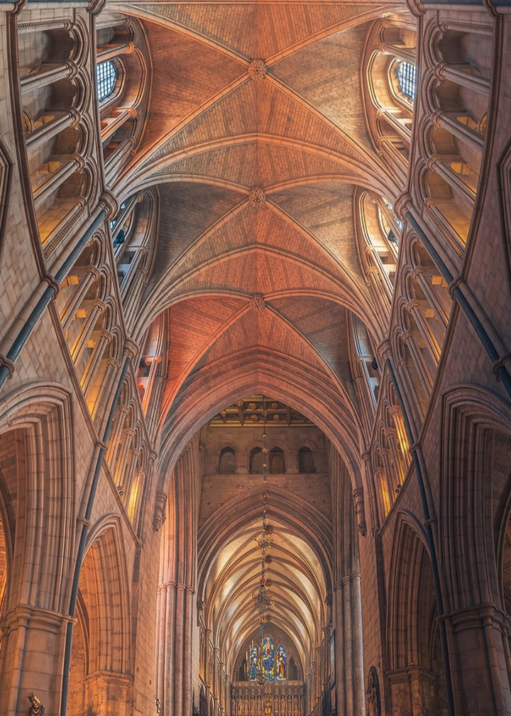 Vertical panoramic photograph of Southwark Cathedral’s nave showing soaring ribbed vaults, pointed arches, chandeliers and stained-glass windows leading to the high altar; a tranquil, symmetrical view dedicated to Doorkins, the cathedral’s beloved resident cat.