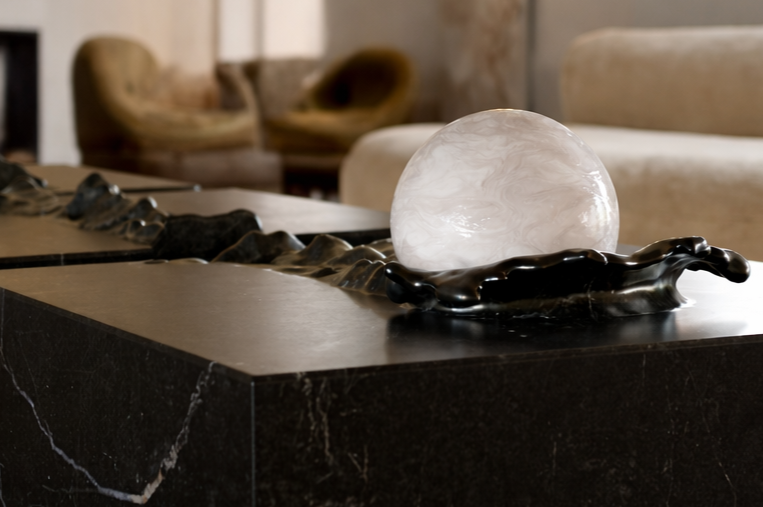 Duffy London Pearl Table sculptural marble coffee table with carved ripple effect and spherical pearl element, creating the illusion of water frozen in motion.