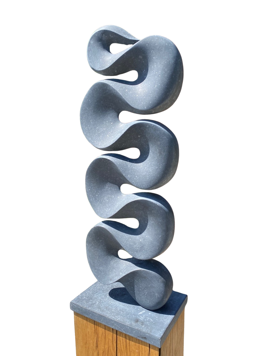 Abstract stone sculpture Ebb & Flow – 2025 by Hamish Holman, carved in deep grey Kilkenny limestone with a tall vertical form of flowing wave-like curves, smooth polished surface with subtle flecks of light grey, mounted on a stone base.
