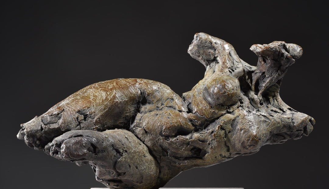 ‘Nude Emergence Torso’ by Hamish Mackie, a limited-edition contemporary bronze figurative sculpture depicting a fragmented reclining female nude torso. Inspired by ancient sculptural artefacts, the abstracted human form features rough, expressive modelling, weathered surfaces and an earthy brown bronze patina. Mounted horizontally on a rectangular Ancaster Weatherbed stone plinth, the sculpture explores the natural beauty and tactile qualities of the female form.