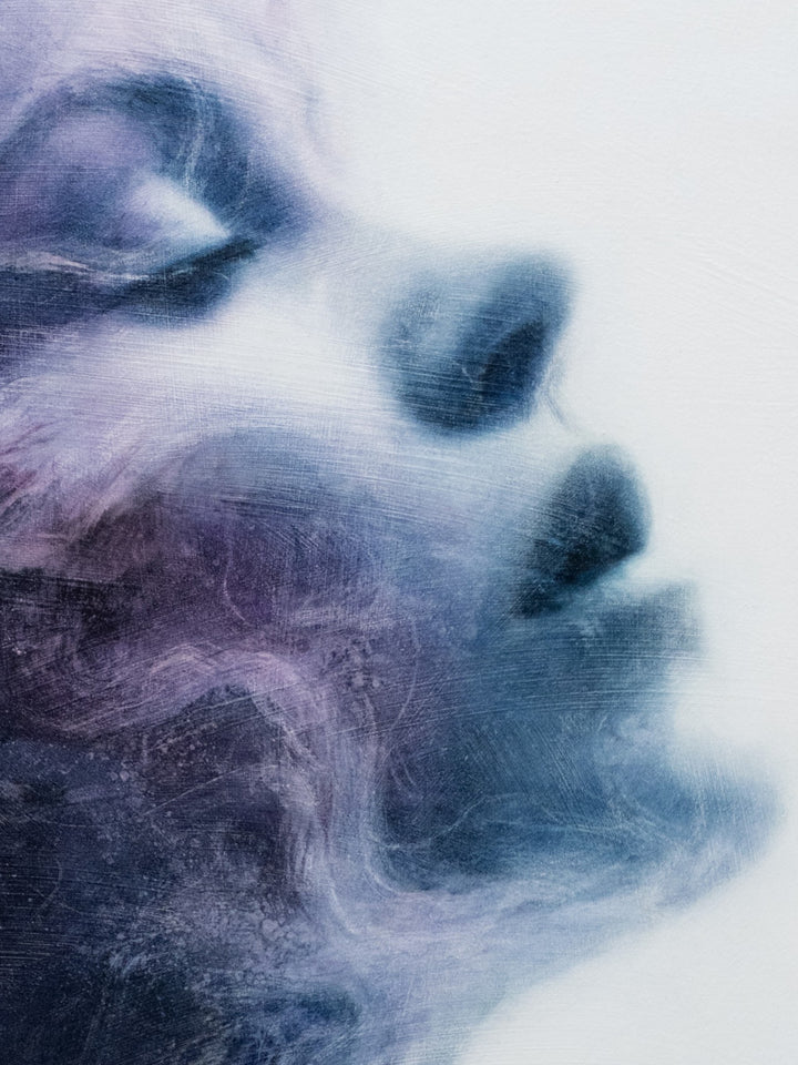 Oil on canvas painting by Dan Bullock, titled Eternal. A dreamlike portrait of a woman’s face in profile, eyes closed, emerging from swirling textures of deep indigo, violet, and soft lavender. The ethereal brushwork gives the impression of smoke or mist, creating a sense of serenity, timelessness, and transcendence.
