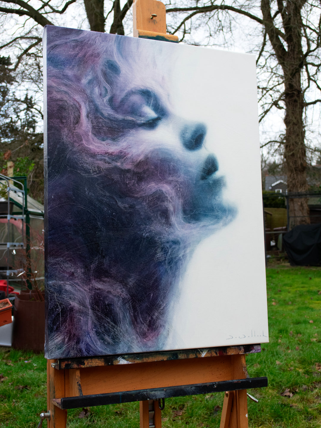 Oil on canvas painting by Dan Bullock, titled Eternal. A dreamlike portrait of a woman’s face in profile, eyes closed, emerging from swirling textures of deep indigo, violet, and soft lavender. The ethereal brushwork gives the impression of smoke or mist, creating a sense of serenity, timelessness, and transcendence.