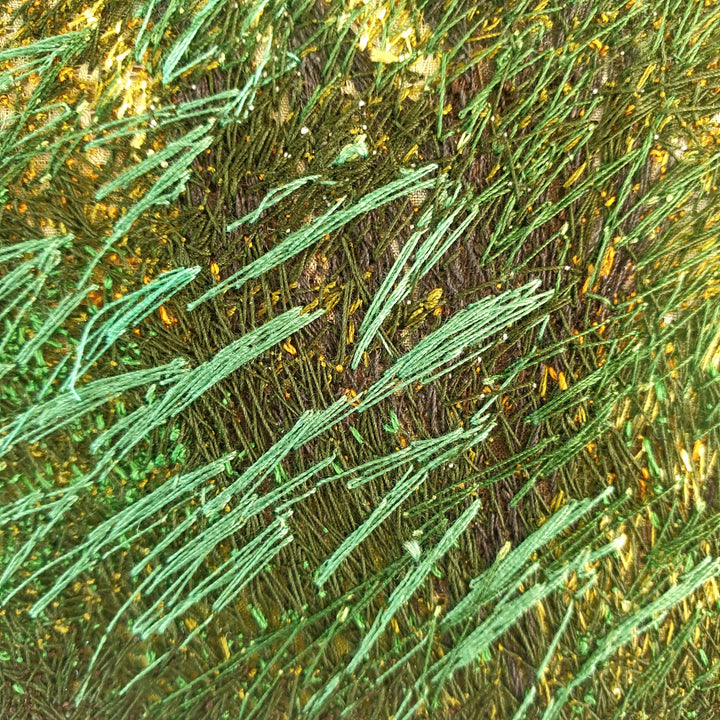 Embroidered woodland with tall trees, golden light filtering through branches, and vivid green and orange grasses in the foreground.