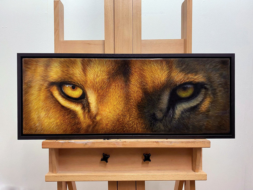 Close-up painting of a lion's and wolf's eyes, side by side, with intense golden-yellow irises and detailed fur textures.