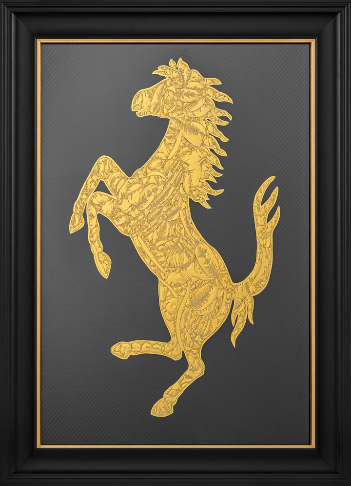Cavallino Carbon by Vince Edmunds, a handcrafted automotive artwork featuring Ferrari’s prancing horse emblem rendered in genuine 24-carat gold leaf and glue chipped glass against a dark carbon fibre background, presented in a satin black frame with a fine gold sight line.