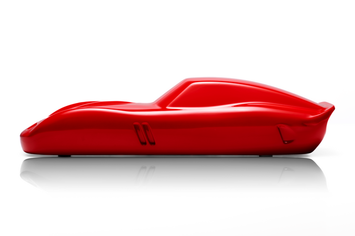 ‘Ferrari 250 GTO’ by Sreeni Gandra, a limited-edition contemporary automotive sculpture from the Forme di Velocità series, inspired by the iconic Ferrari 250 GTO designed by Sergio Scaglietti. Presented in a striking high-gloss Rosso Corsa red finish, the sculpture captures the car's flowing aerodynamic silhouette, elongated bonnet, sculpted wheel arches, distinctive triple front air intakes and elegant fastback roofline. Its smooth, minimalist surfaces celebrate the pure form and timeless character of one 