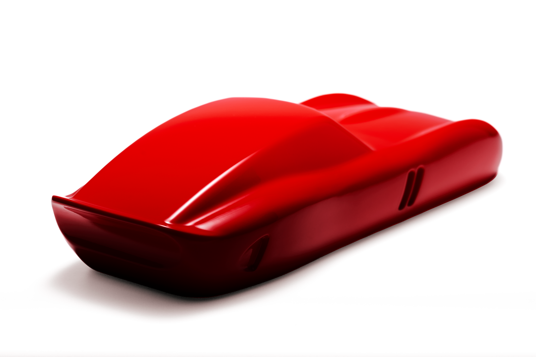‘Ferrari 250 GTO’ by Sreeni Gandra, a limited-edition contemporary automotive sculpture from the Forme di Velocità series, inspired by the iconic Ferrari 250 GTO designed by Sergio Scaglietti. Presented in a striking high-gloss Rosso Corsa red finish, the sculpture captures the car's flowing aerodynamic silhouette, elongated bonnet, sculpted wheel arches, distinctive triple front air intakes and elegant fastback roofline. Its smooth, minimalist surfaces celebrate the pure form and timeless character of one 