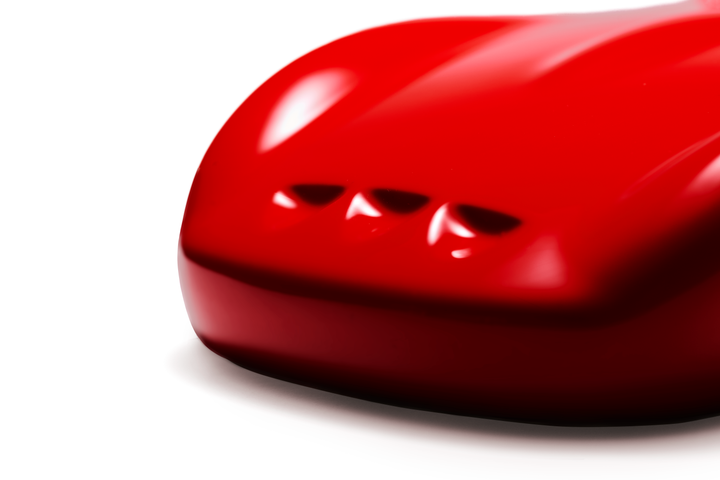 ‘Ferrari 250 GTO’ by Sreeni Gandra, a limited-edition contemporary automotive sculpture from the Forme di Velocità series, inspired by the iconic Ferrari 250 GTO designed by Sergio Scaglietti. Presented in a striking high-gloss Rosso Corsa red finish, the sculpture captures the car's flowing aerodynamic silhouette, elongated bonnet, sculpted wheel arches, distinctive triple front air intakes and elegant fastback roofline. Its smooth, minimalist surfaces celebrate the pure form and timeless character of one 