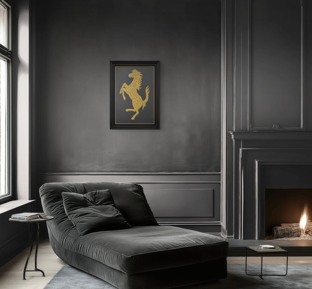 Cavallino Carbon by Vince Edmunds, a handcrafted automotive artwork featuring Ferrari’s prancing horse emblem rendered in genuine 24-carat gold leaf and glue chipped glass against a dark carbon fibre background, presented in a satin black frame with a fine gold sight line.