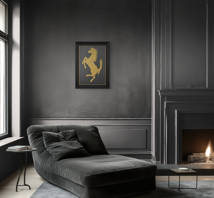 Cavallino Carbon by Vince Edmunds, a handcrafted automotive artwork featuring Ferrari’s prancing horse emblem rendered in genuine 24-carat gold leaf and glue chipped glass against a dark carbon fibre background, presented in a satin black frame with a fine gold sight line.