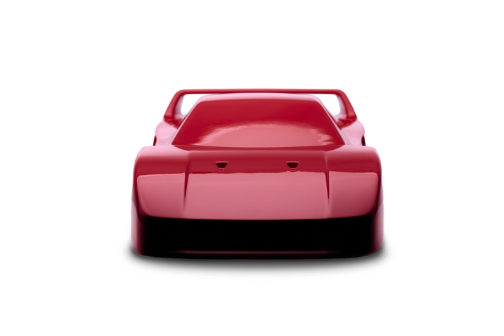 ‘Ferrari F40’ by Srini Gandra, a limited-edition contemporary automotive sculpture from the Forme di Velocità series, inspired by the legendary Ferrari F40, the final Ferrari personally approved by Enzo Ferrari. Presented in a striking high-gloss Rosso Corsa red finish, the sculpture captures the supercar's low wedge-shaped profile, sculpted bonnet, aerodynamic side intakes, distinctive rear engine vents and iconic elevated rear wing. Its smooth, minimalist surfaces celebrate the raw performance, aerodynami
