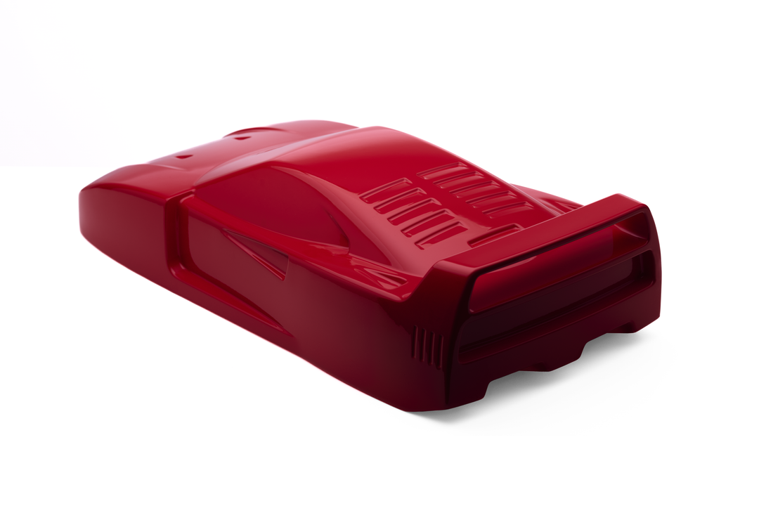 ‘Ferrari F40’ by Srini Gandra, a limited-edition contemporary automotive sculpture from the Forme di Velocità series, inspired by the legendary Ferrari F40, the final Ferrari personally approved by Enzo Ferrari. Presented in a striking high-gloss Rosso Corsa red finish, the sculpture captures the supercar's low wedge-shaped profile, sculpted bonnet, aerodynamic side intakes, distinctive rear engine vents and iconic elevated rear wing. Its smooth, minimalist surfaces celebrate the raw performance, aerodynami
