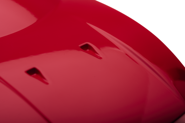 ‘Ferrari F40’ by Srini Gandra, a limited-edition contemporary automotive sculpture from the Forme di Velocità series, inspired by the legendary Ferrari F40, the final Ferrari personally approved by Enzo Ferrari. Presented in a striking high-gloss Rosso Corsa red finish, the sculpture captures the supercar's low wedge-shaped profile, sculpted bonnet, aerodynamic side intakes, distinctive rear engine vents and iconic elevated rear wing. Its smooth, minimalist surfaces celebrate the raw performance, aerodynami